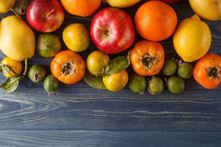 Fresh organic fruits and vegetables on wooden background