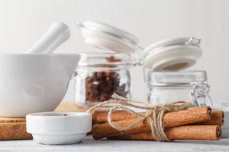 spices in glass jars on rustic wooden tableの写真素材