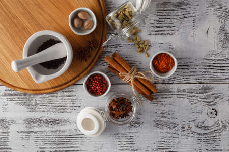 Various spices and herbs on white tableの写真素材