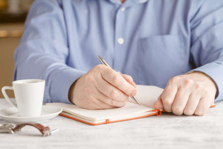 Businessman in a blue jacket with a cup of coffee