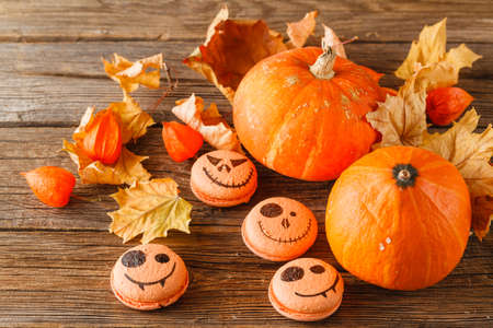 Autumn scene with pumpkin and colorful leaves on wooden tableの写真素材