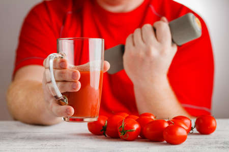 Tomato juice in man handの写真素材