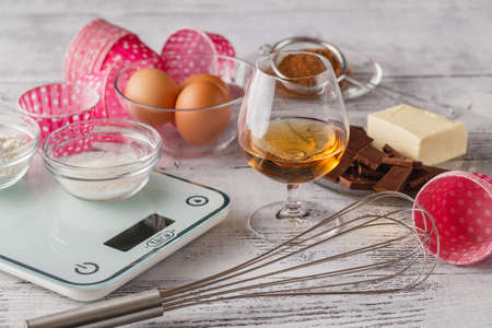 Cookies ingredients (raw egg, brown sugar, apple, butter and flour) over rustic wood with copyspace. Top view.の写真素材