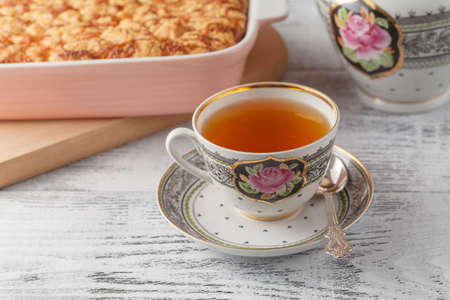 Delicious homemade lemon tart pie with green tea on rustic white tableの写真素材