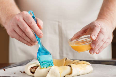 Woman Making Swirl Brioche with chocolate, Chocolate roll bread, chocolate pull apart rolls, Chocolate Babka, Povitica: traditional Polish sweet Christmas breadの写真素材