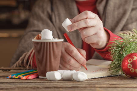 man with mug hot cocoa with marshmallows, winter Christmas drinkの写真素材
