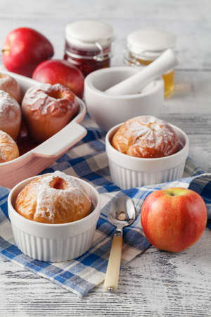 Baked apples on wooden table, christmas dinnerの写真素材