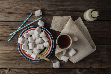 Cup of hot cocoa with marshmallows on the wooden table, top viewの写真素材