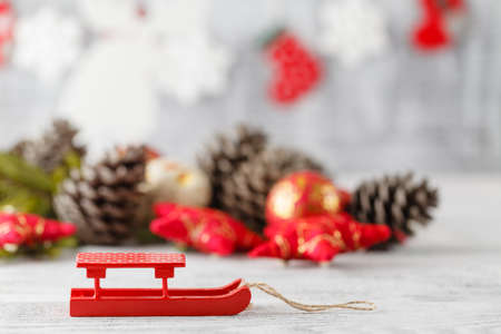Holiday decoration with Christmas lights and cones over wooden backgroundの写真素材