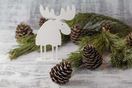 Funny christmas card with reindeer  for a greetings on a wooden backgroundの写真素材