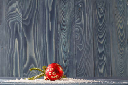 Red Christmas decorations on spruce branches with snowの写真素材