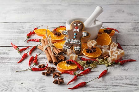 Christmas decoration on wooden background with cinnamon, orange, nuts