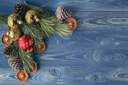 Christmas tale. The frame of the trees.Themes Christmas decorations, fir cones, snow and festive moodの写真素材