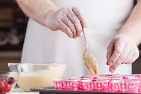 The process of preparing cupcakes in the kitchen, ingredients closeup horizontalの写真素材