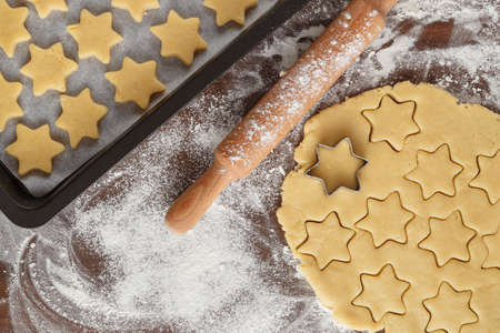 Christmas cookies in the shape of stars on a wooden board, close-upの写真素材