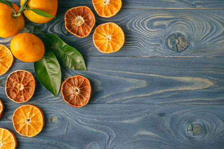 Dried orange slices on a blue wooden tableの写真素材