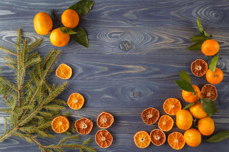 Slices of dried orange, lemon, cinnamon, cloves, cardamom and pine cone. Christmas and New Year decoration. Free space for textの写真素材