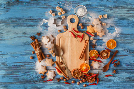 Top view of wooden board with Christmas baking ingredients.の写真素材