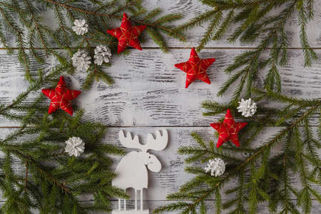 Wooden white christmas deer decoration on wooden background. Chistmas consept. Top view.の写真素材