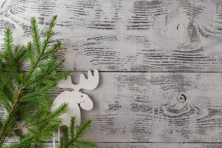 Wooden white christmas deer decoration on wooden background. Chistmas consept. Top viewの写真素材