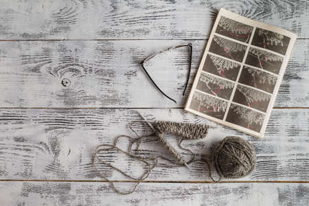Incomplete knitting project with ball of grey woolの写真素材