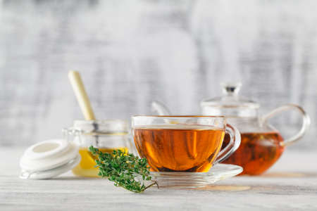 cup of thyme tea, fresh thyme on the old wooden backgroundの写真素材