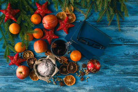 christmas hot mulled wine with cinnamon cardamom and anise on wooden background