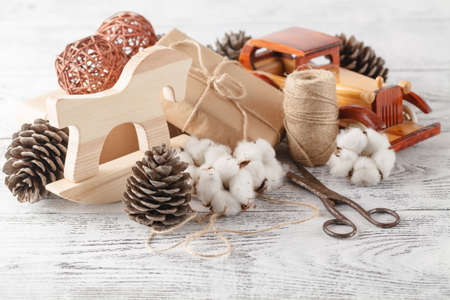 Homemade wrapped christmas present on wooden surfaceの写真素材