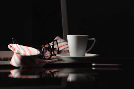 Workspace work desktop with laptop an cup of coffee. Later night