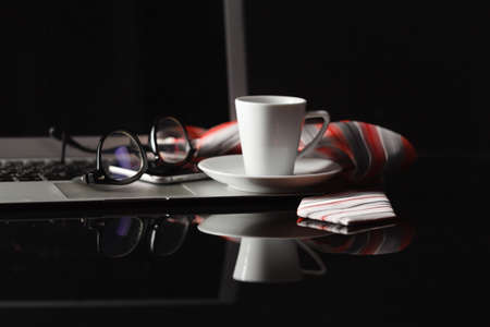 Cup of hot espresso coffee on wood table, espresso brew from arabica coffee with laptop and smartphone, close up shot office table with coffee nightの写真素材