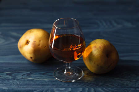 traditional fruit brandy and pears on a vintage grunge wooden backgroundの写真素材
