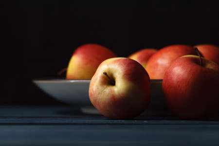 Fresh red apples on wooden blue backgroundの写真素材