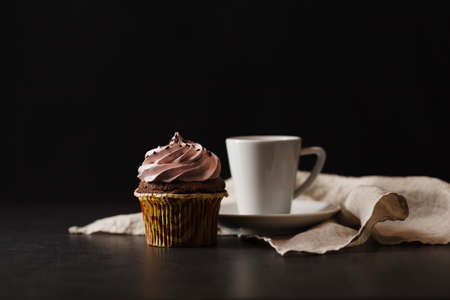 Tasty and good aroma black coffee in white cup and beautiful decorate cupcake