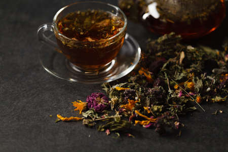 Herbal tea in glass cp on dark stone backgroundの写真素材