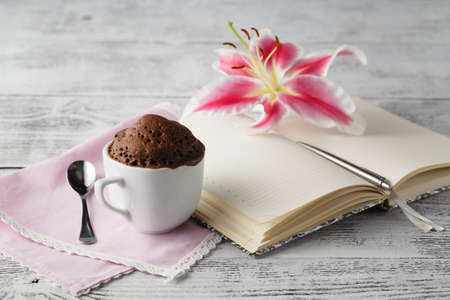 Cup cake in teacup with coffeeの写真素材