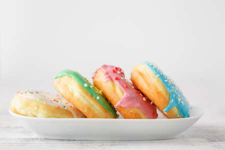 few colourfull donuts on plateの写真素材