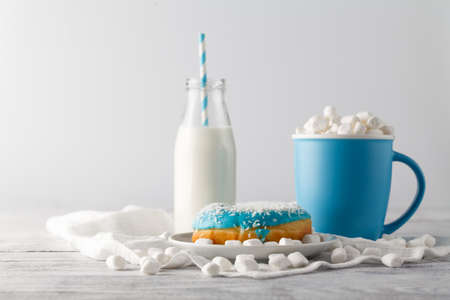 Mlue donut and cup o white tableの写真素材