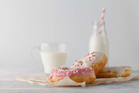 Donuts with glass of milk on wooden tableの写真素材