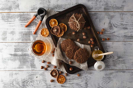Oat cookies on vintage tray with nutsの写真素材