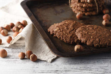 Oat cookies on vintage tray with nutsの写真素材