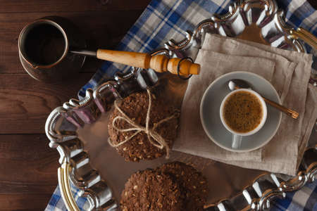 Breakfast with ciikies and coffee on rural table