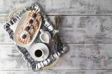 Few wafers on table with berries and coffeeの写真素材