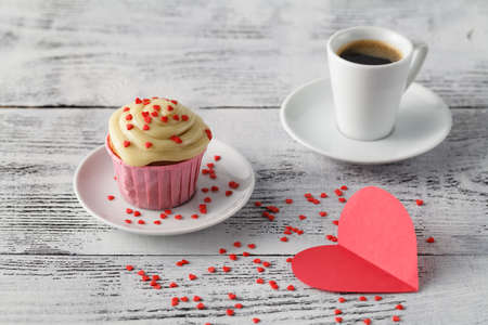 Expresso coffee cup and muffins decorated with heartsの写真素材