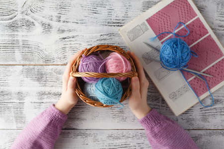 Leisure hobby concept, clew of natural wool on table