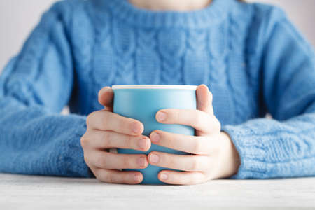 big mug of coffee in handsの写真素材