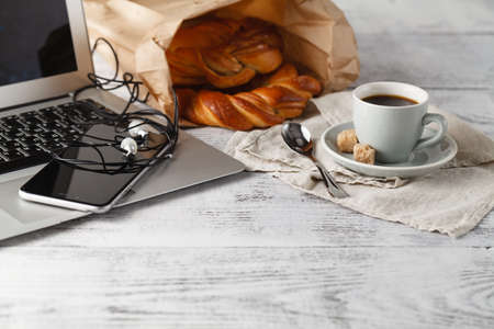 ????? on work time. cup of brew coffee on table in office with laptopの写真素材