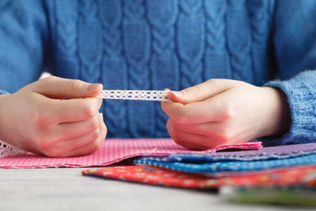 Girl saw lace tape to clothesの写真素材