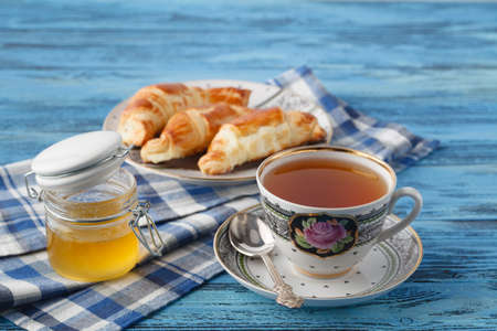 croissant and tea in mug. Breakfast conceptの写真素材