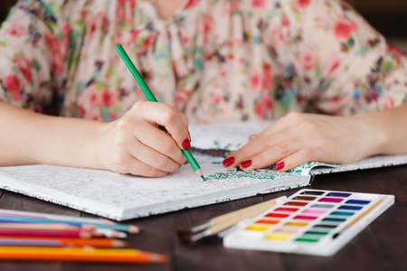 Adult woman relax by paining coloring bookの写真素材