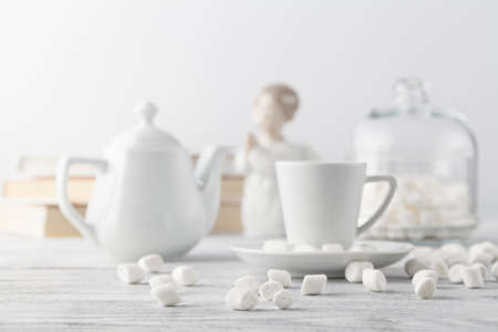 Coffee in white porcelain cup on wooden tableの写真素材